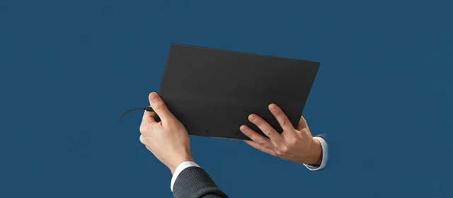 Person holding YODOIT tablet in blue studio environment, showcasing premium product quality